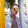 CANNON BALL Polarised Orange Mirrored Shield Sunglasses made of recycled plastic on male model with tattoos