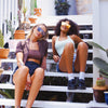 CANNON BALL Polarised Orange Mirrored Shield Sunglasses made of recycled plastic on on female model sitting on stairs