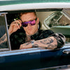 CANNON BALL Polarised Shield Sunglasses with Pink Mirror on a male model sitting in a classic car