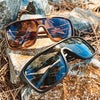 JACKPOT Polarised Shield Sunglasses with Black Frame and Black Lens on a stone along with another colour