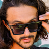 LOOSE CANNON Polarised Black Gradient Shield Square Sunglasses on a male model looking down