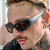 Reefer Polarised Black Wrap Around Sunglasses made of recycled plastic on male model looking side on