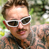 Reefer Polarised White Wrap Around Sunglasses made of recycled plastic on male model with tattoos