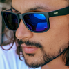 Riot Polarised Matt Black Rectangle Sunglasses with Blue Lens side view on a male model
