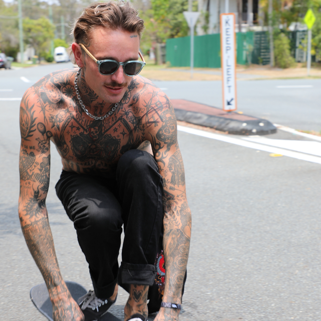Risky Business Polarised Blue Round Wooden Sunglasses on a male model skateboarding on the street