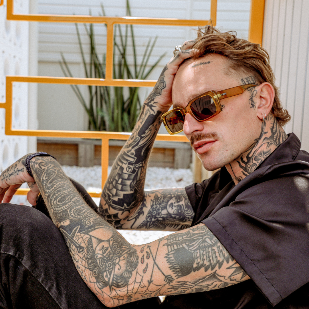 Rocker Polarised Green Rectangle Sunglasses on a male model brushing his hair