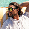 Spartan Recycled Black Rectangle Sunglasses with gold matte lens left side view on a male model