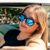 Spartan Recycled Rectangle Sunglasses with Black Frame and Blue Matte lens on a female surfer looking up