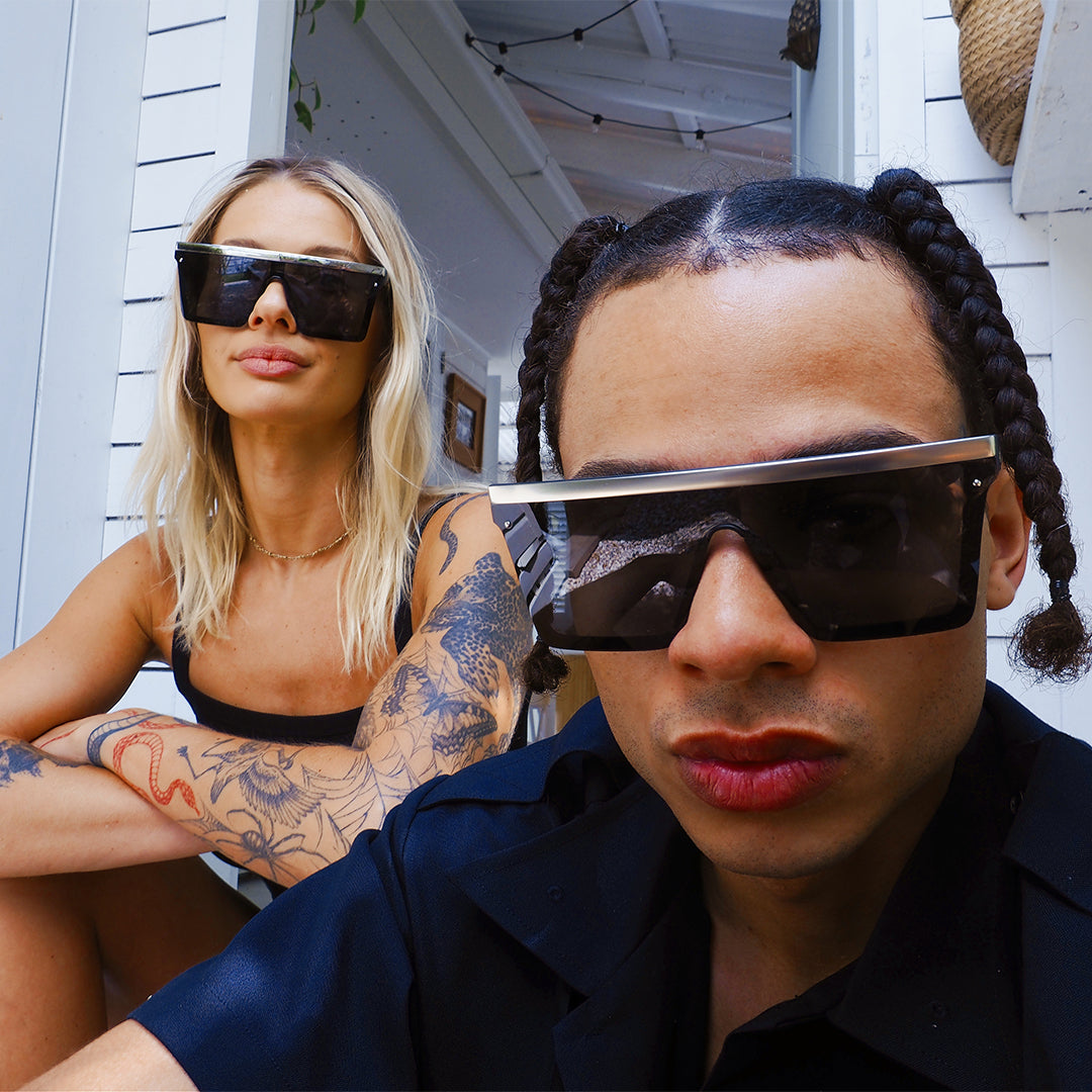 THE BAR Polarised Black Shiny Silver Square Sunglasses on a female model with a male model