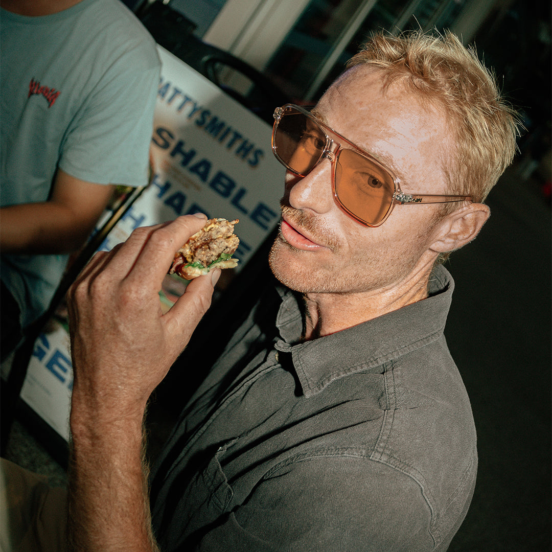 The Duke Crystal Sand Brown worn by male surfer eating burger
