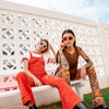 Ahoy Polarised Rectangle Sunglasses with Orange Frame on a female model sitting with another model
