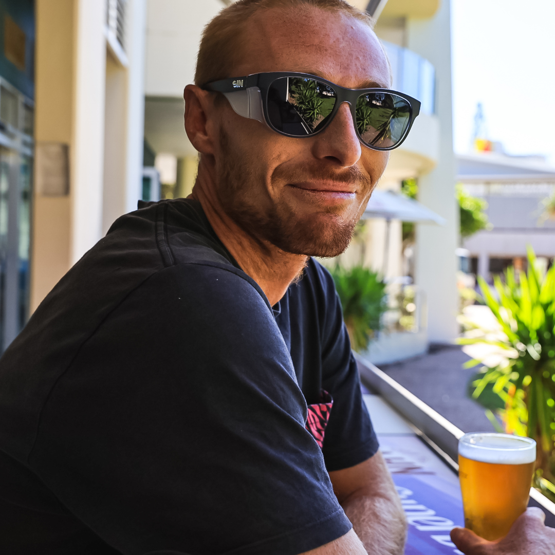 Safe & Sound Black Wrap Around Medium Impact Resistant Safety Sunglasses on a Male Tradie smiling