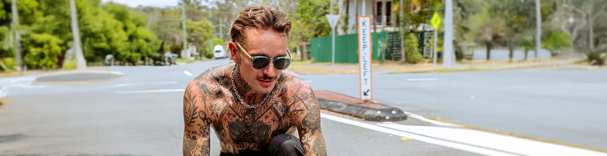 male model wearing SIN wooden sunglasses riding a skateboard