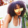 CANNON BALL Polarised Orange Mirrored Shield Sunglasses made of recycled plastic on female model with curly hair
