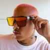 LOOSE CANNON Polarised Red Shield Square Sunglasses on a male model
