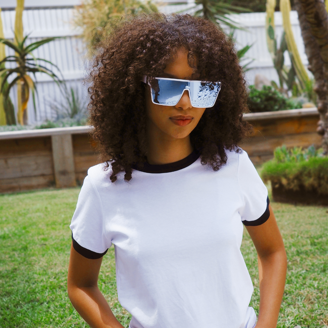 LOOSE CANNON Polarised White Shield Square Sunglasses with Blue Mirrored Lens on a female model with dark hair