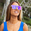 LOOSE CANNON Polarised White Shield Square Sunglasses with Purple Mirrored Lens on a female surfer