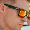 Peccant Polarised Black Rectangle Sunglasses with Red Lens side view on a male model