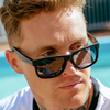 Riot Polarised Matt Black Rectangle Sunglasses close up on a male model
