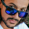 Riot Polarised Matt Black Rectangle Sunglasses with Blue Lens close up on a male model
