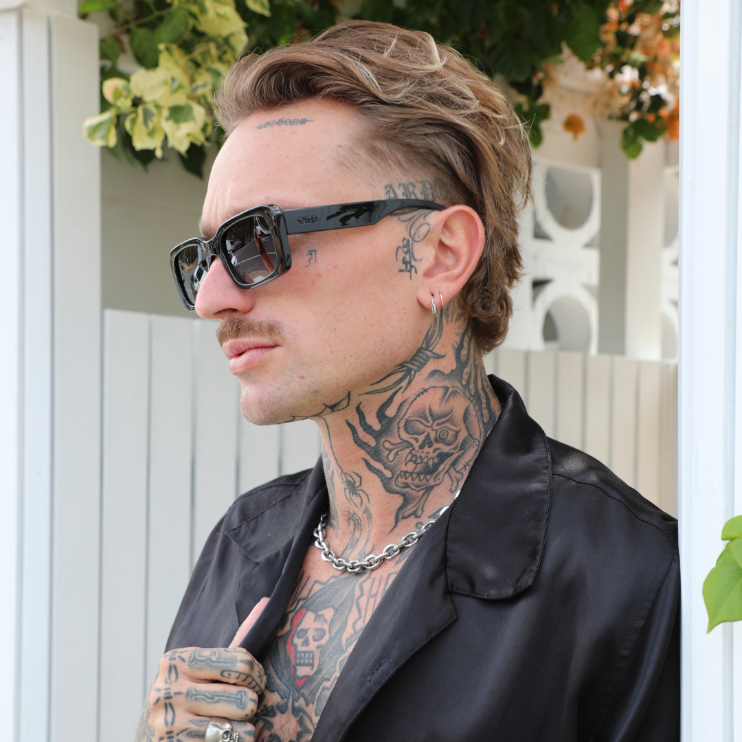 Rocker Polarised Black Rectangle Sunglasses on a male model looking to the side