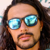 Spartan Recycled Black Rectangle Sunglasses with blue matte lens on a male model looking at the camera