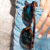 Vegas Polarised Tortoise Shell Round Sunglasses in a pair of jeans