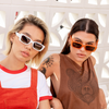 Ahoy Polarised Orange Rectangle Sunglasses on a brunette female model sitting with another model