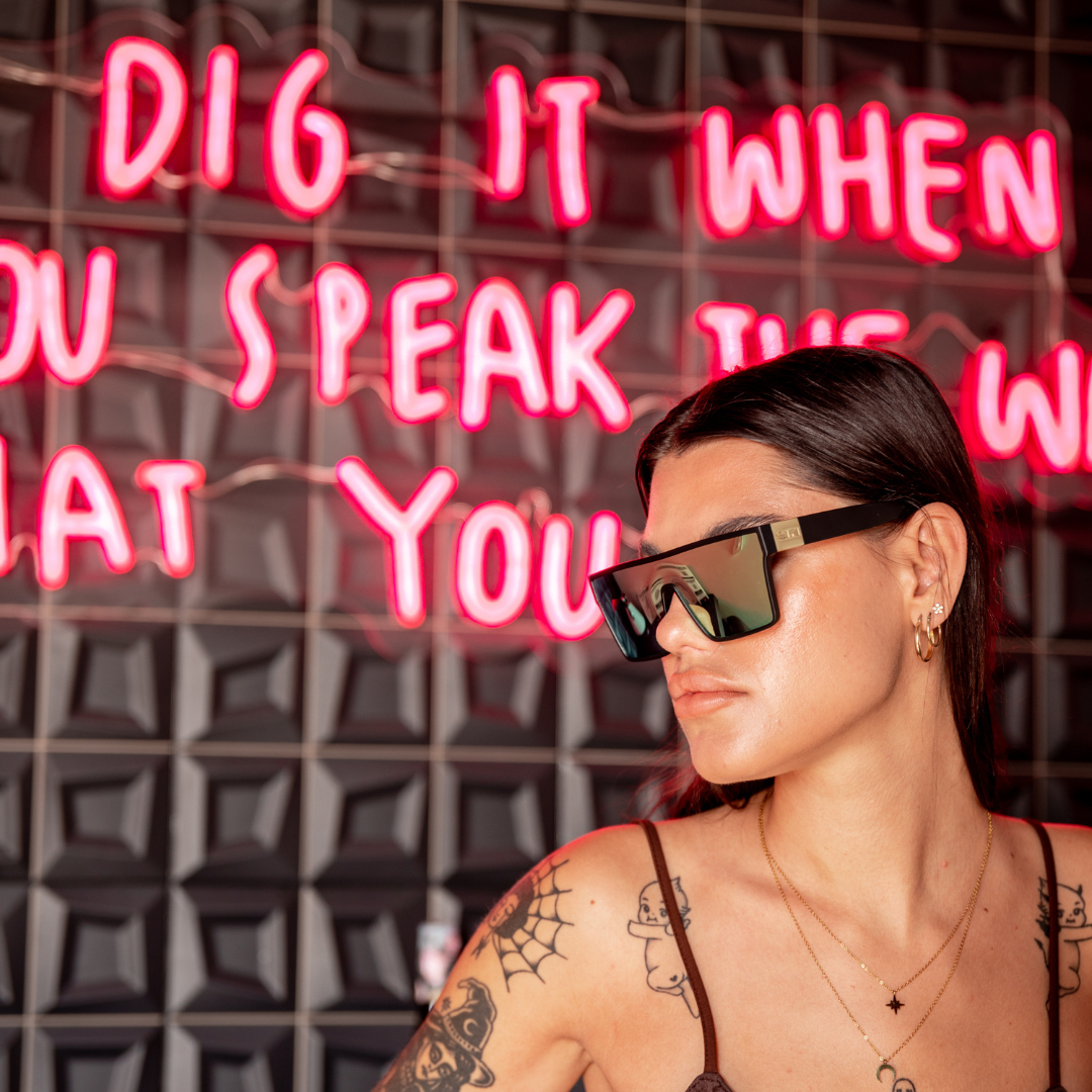LOOSE CANNON Polarised Gold Shield Square Sunglasses side view on a female model
