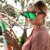 LOOSE CANNON Polarised Green Square Sunglasses on a female surfer