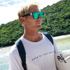 LOOSE CANNON Polarised Green Square Sunglasses on a male surfer