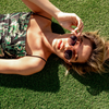 LOVE CHILD Polarised Pink Round Sunglasses on a female model lying down