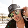 SIN Sun Chasers Black Bucket Hat on a male model near the beach